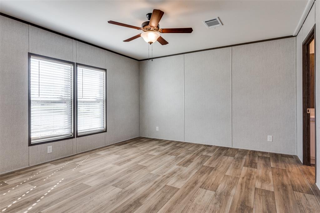 175 Cedar Drive Azle, TX 76020 - Photo 17 of 25 a view of an empty room with a window and a ceiling fan