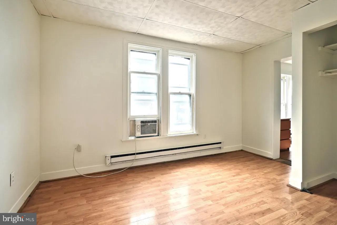 504 Baltimore Street, Unit 3 Gettysburg, PA 17325 - Photo 2 of 5 an empty room with wooden floor and windows