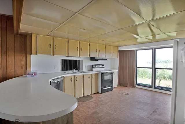 a kitchen with cabinets appliances and a counter top space