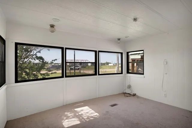 an empty room with windows and closet