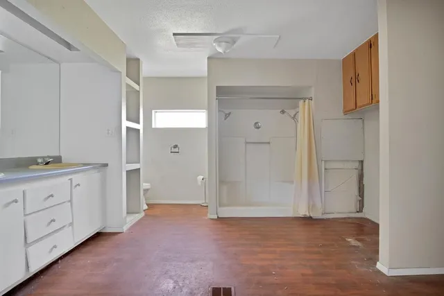 a room with white cabinets and sink