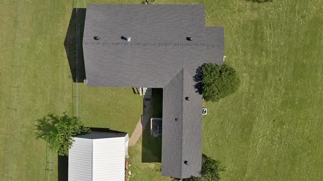 an aerial view of a house with a backyard space