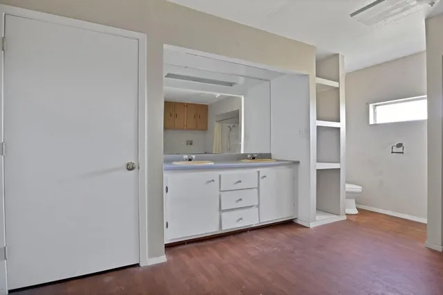 a view of a room with wooden floor