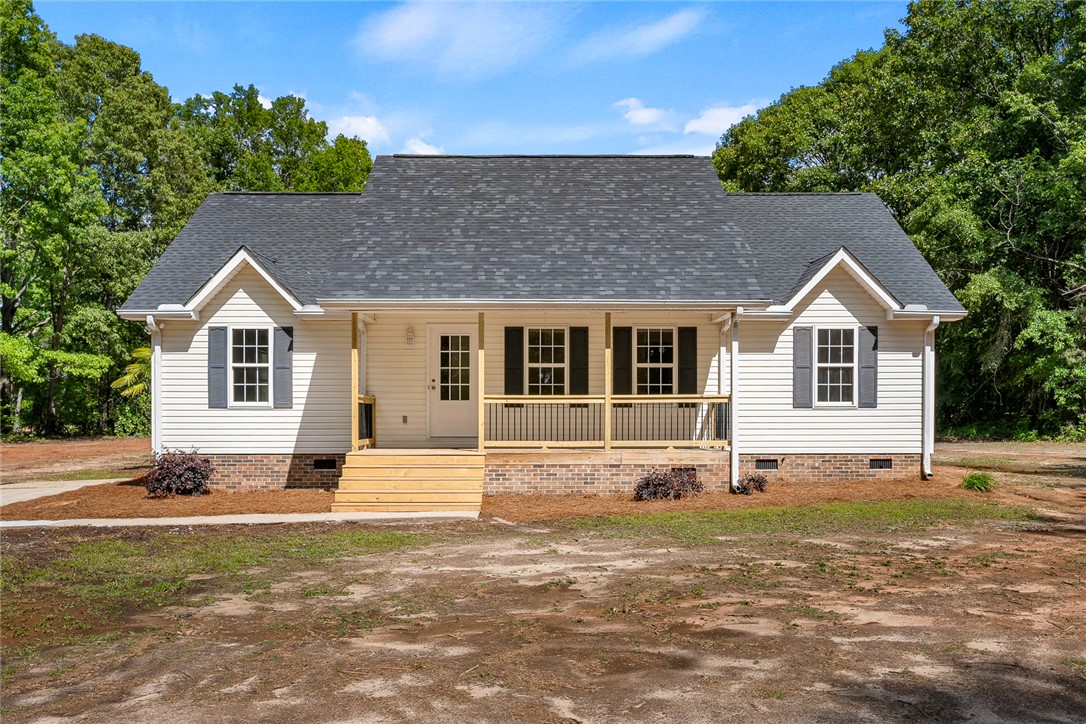 131 Lockaby Road Pelzer, SC 29669 - Photo 9 of 50 This charming home offers a welcoming facade with a covered porch and traditional appeal.