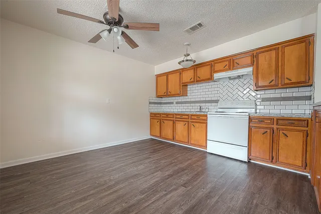 a kitchen with stainless steel appliances granite countertop a sink and cabinets