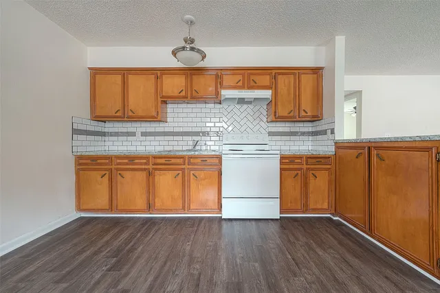 a kitchen with stainless steel appliances granite countertop a sink and cabinets