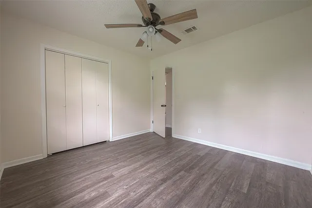 a bathroom with a granite countertop sink a toilet and a mirror