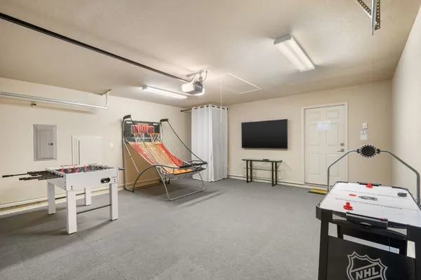 a bedroom with a bed window and a flat screen tv