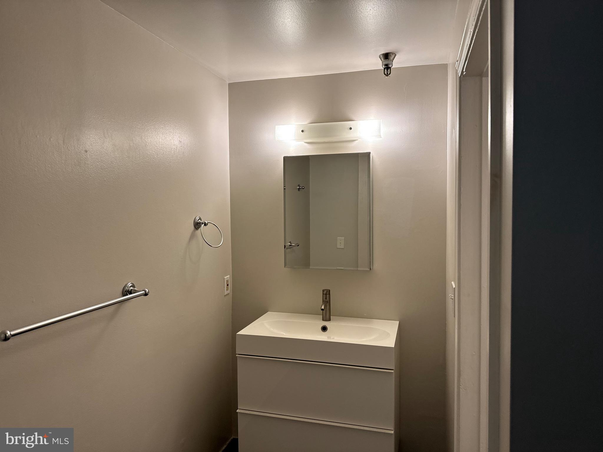 222 Church Street, Unit 5B Philadelphia, PA 19106 - Photo 11 of 15 a bathroom with a sink and mirror