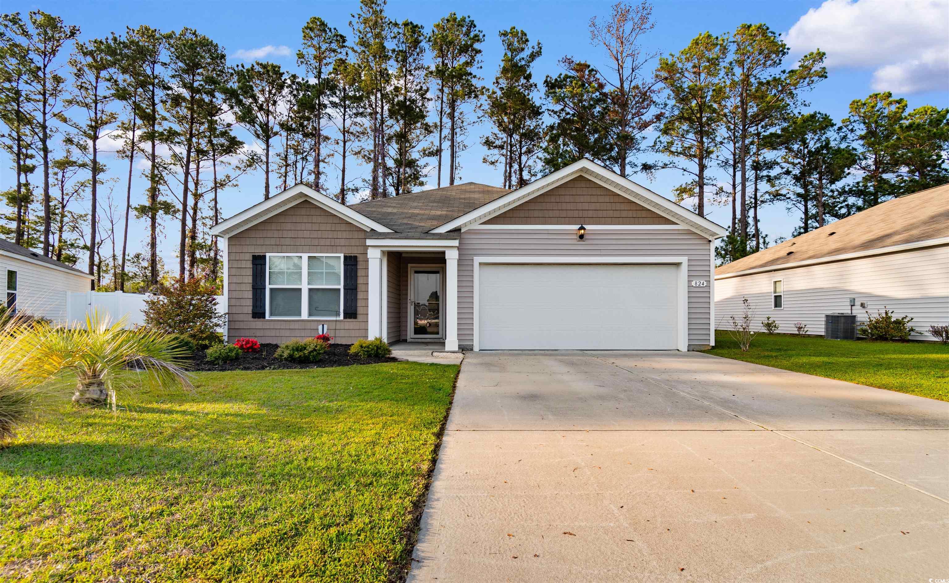View of front of house with driveway, fence, a fro
