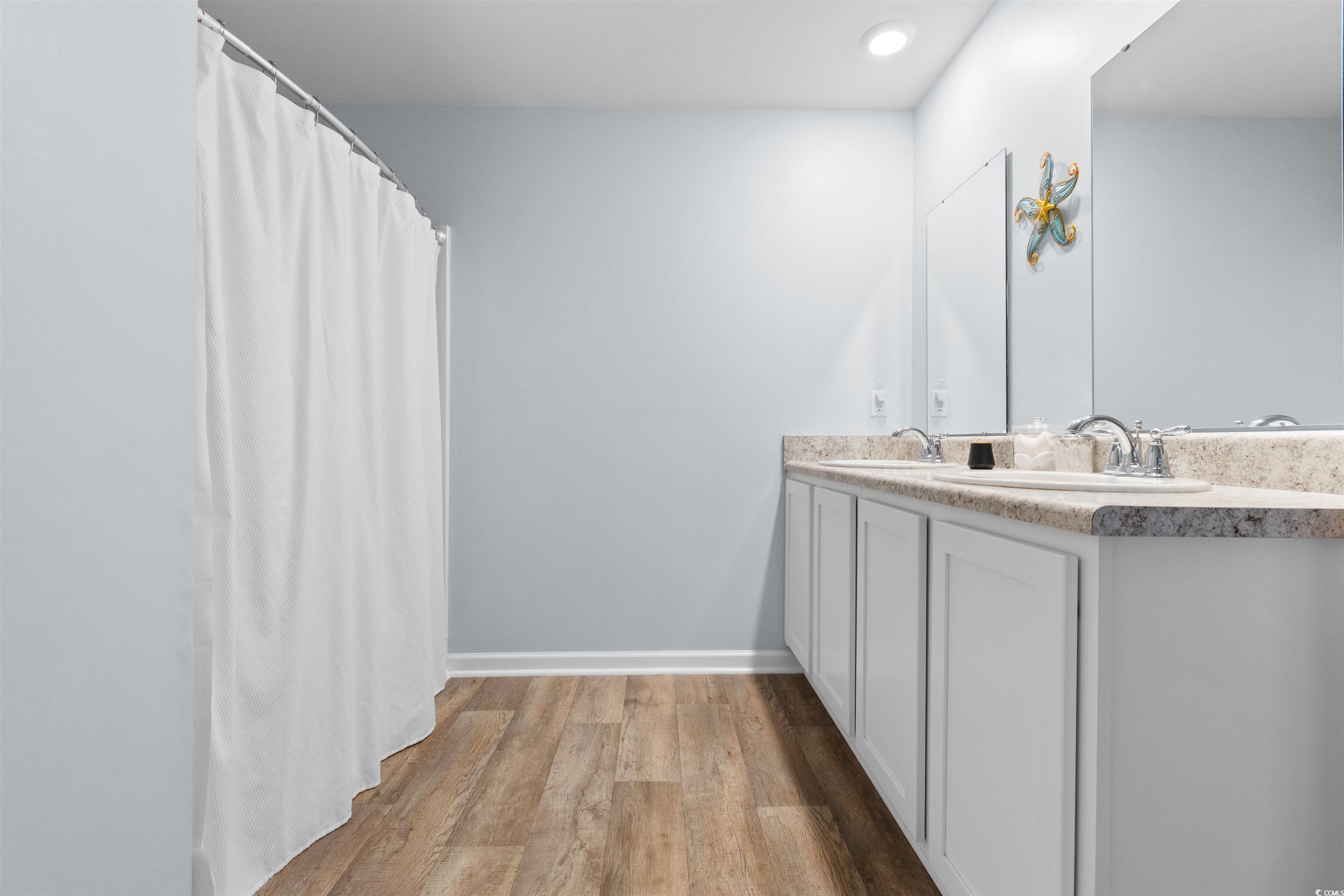 824 Twickenham Loop Longs, SC 29568 - Photo 13 of 27 Bathroom featuring double vanity, a sink, baseboar