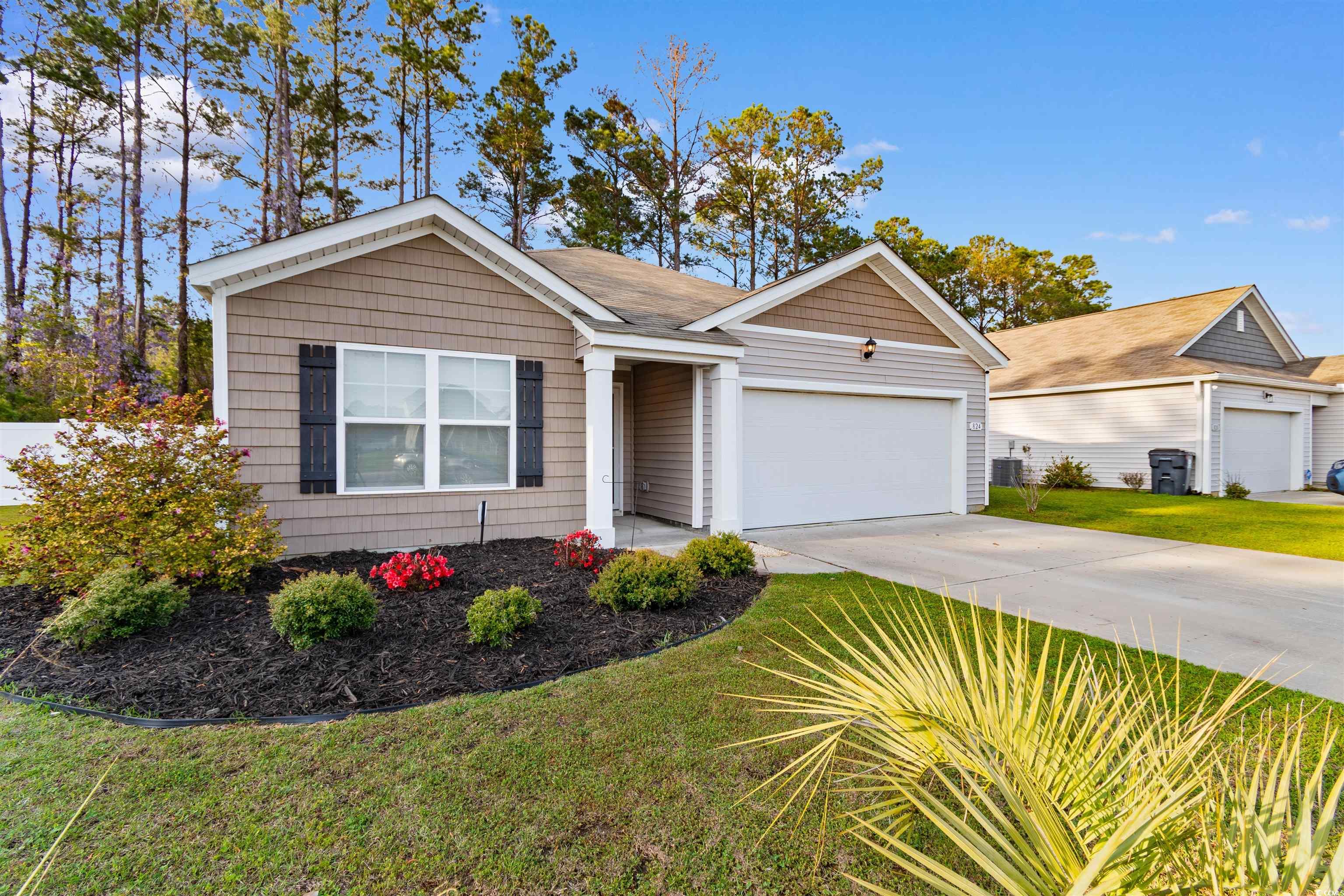 824 Twickenham Loop Longs, SC 29568 - Photo 2 of 27 Single story home with a front yard, concrete driv