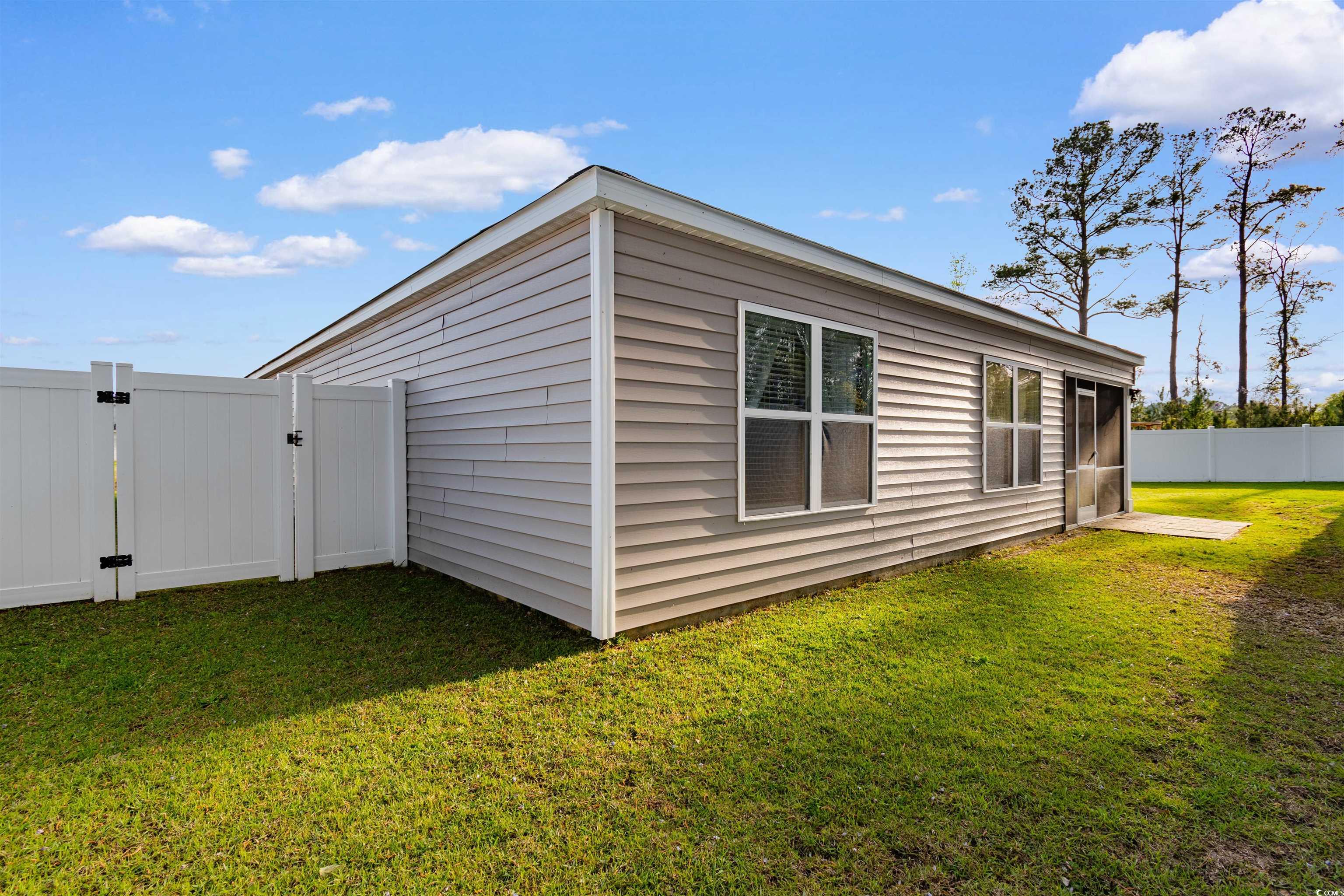 824 Twickenham Loop Longs, SC 29568 - Photo 24 of 27 View of side of property with a lawn, a gate, and