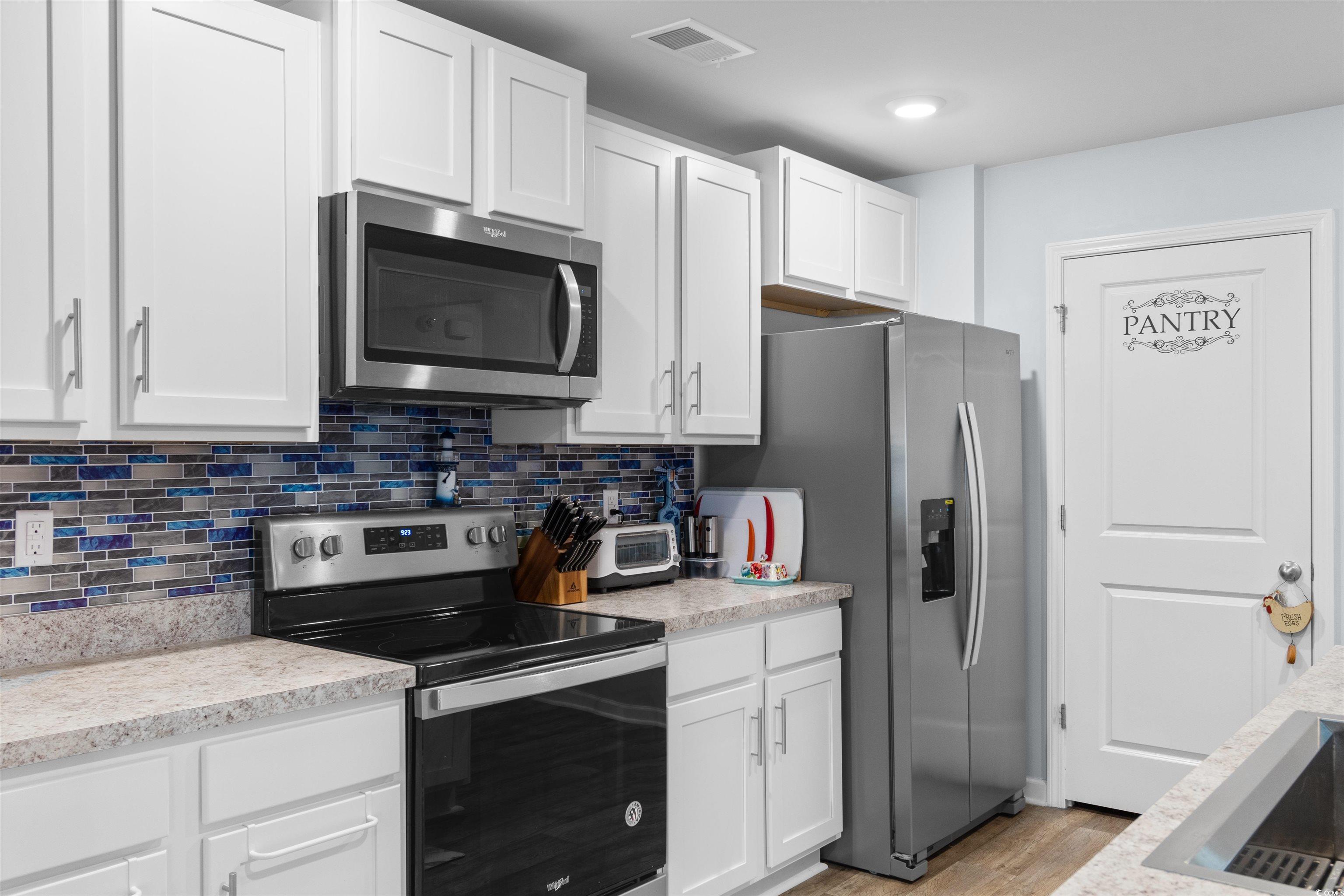 824 Twickenham Loop Longs, SC 29568 - Photo 6 of 27 Kitchen with white cabinetry, tasteful backsplash,