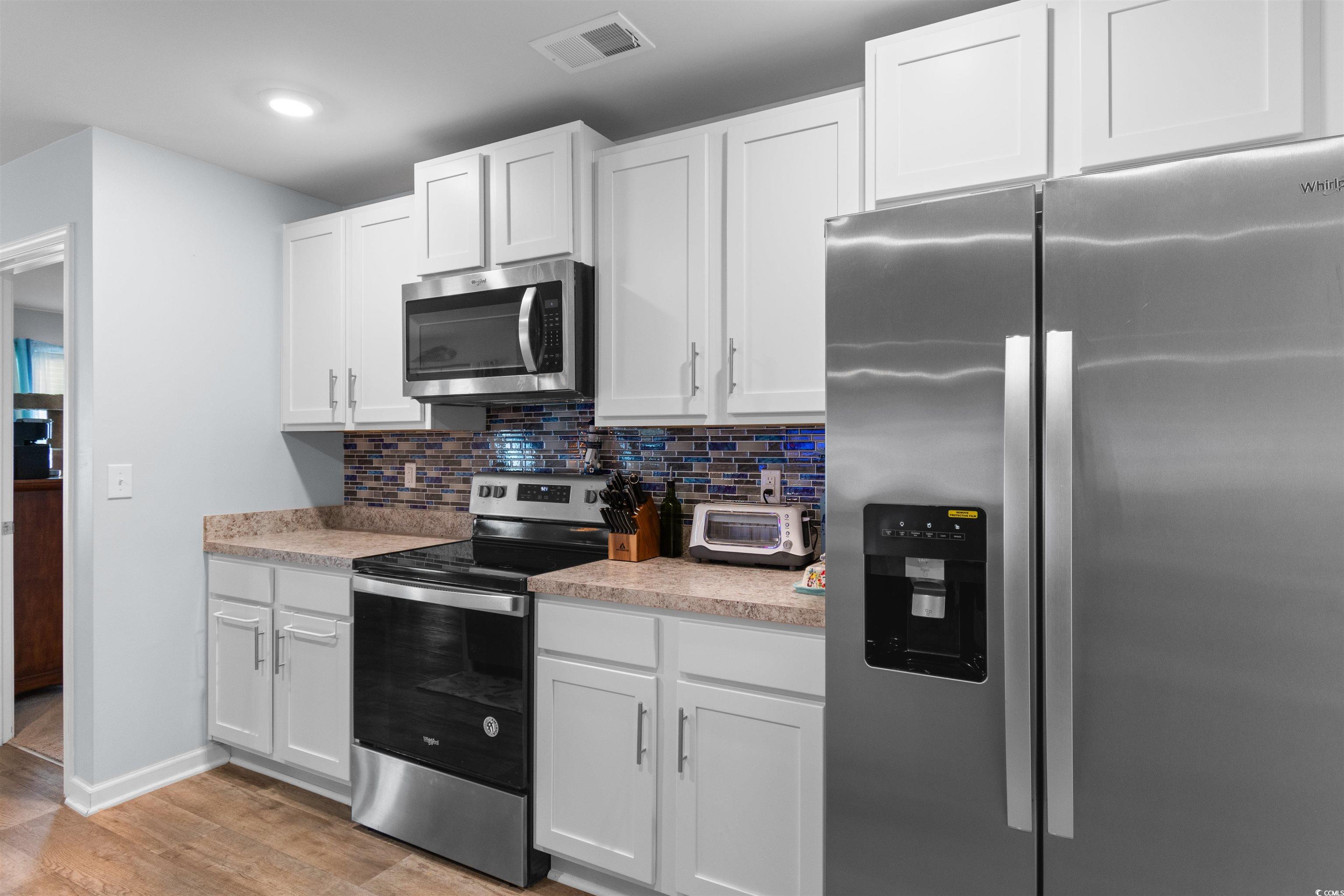 824 Twickenham Loop Longs, SC 29568 - Photo 7 of 27 Kitchen with decorative backsplash, light countert