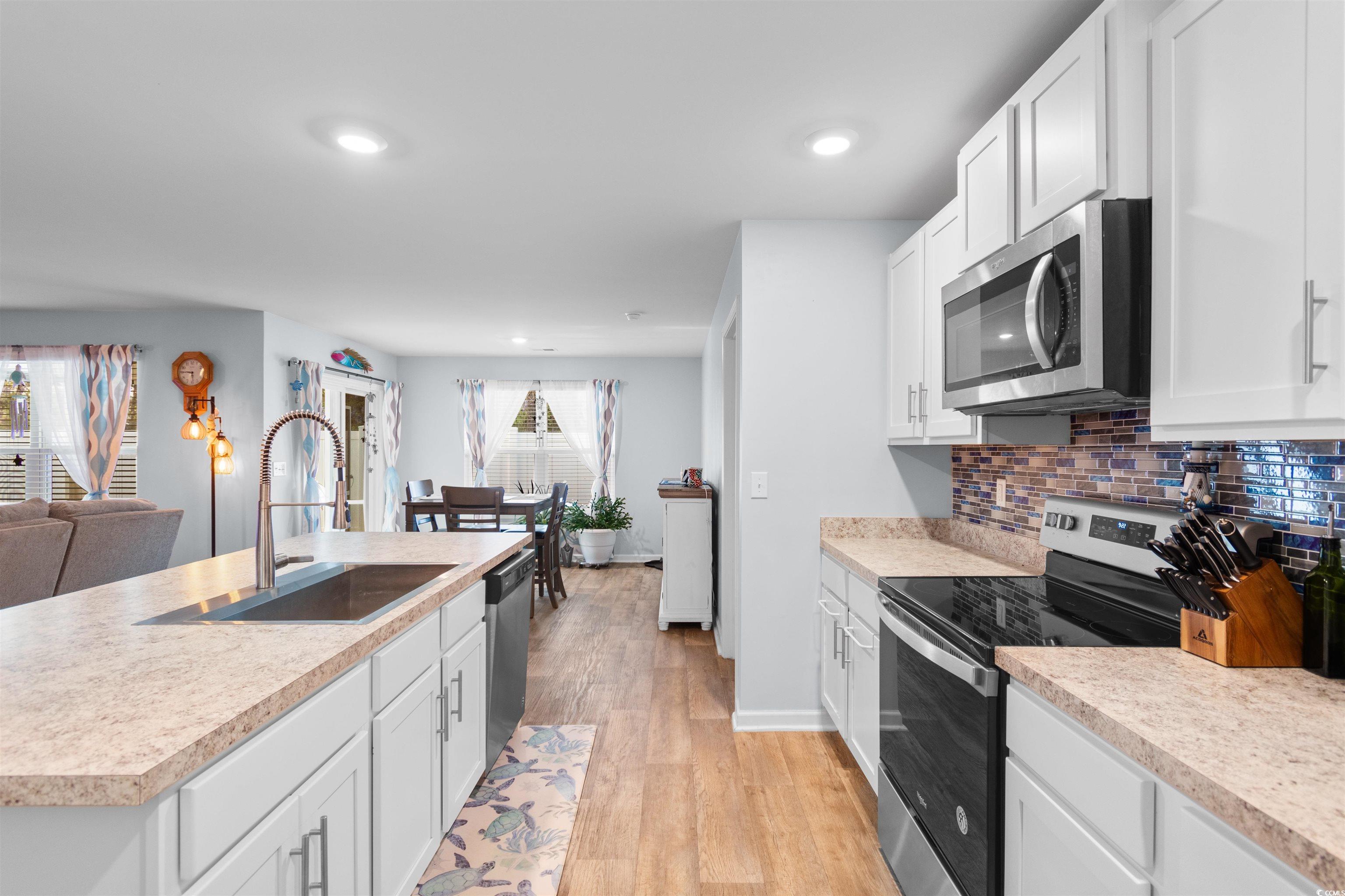 824 Twickenham Loop Longs, SC 29568 - Photo 8 of 27 Kitchen featuring light countertops, a sink, backs