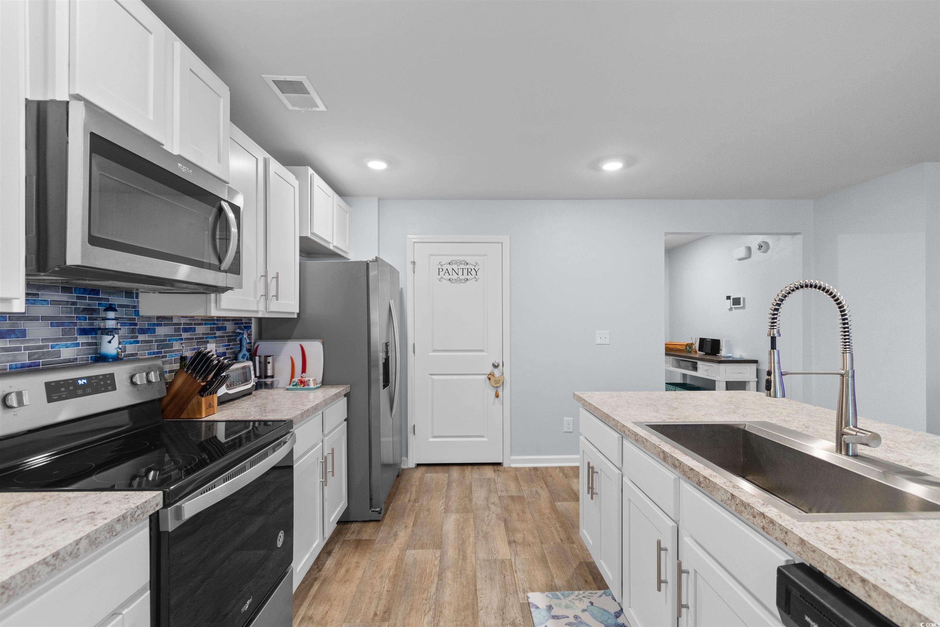 824 Twickenham Loop Longs, SC 29568 - Photo 9 of 27 Kitchen featuring a sink, backsplash, light wood f