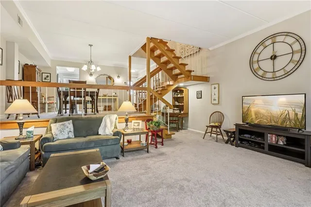 a living room with furniture a window and a flat screen tv