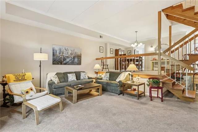a living room with furniture a ceiling fan and a rug