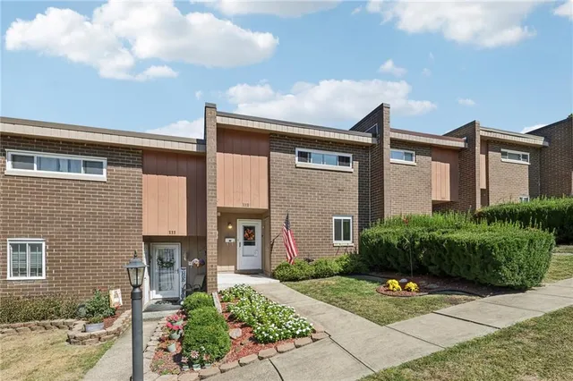 a front view of house and yard with green space