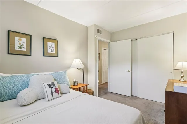 a bedroom with a bed and a couch