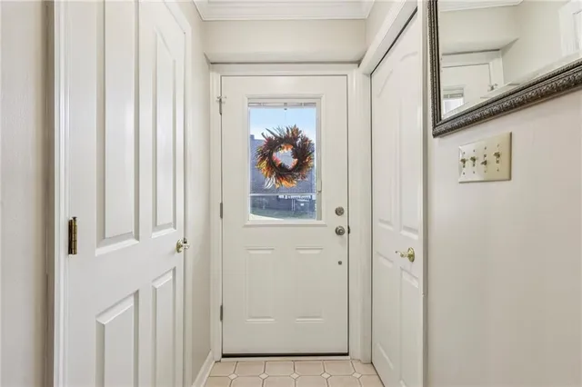 a view of a hallway with wooden floor and a window