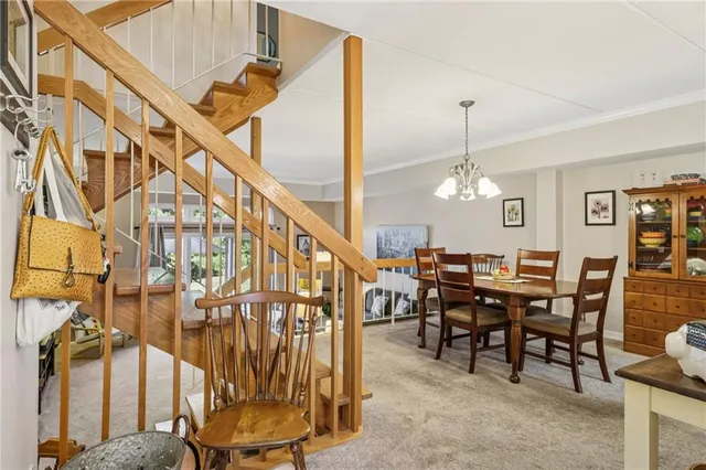a view of a livingroom with furniture and stairs