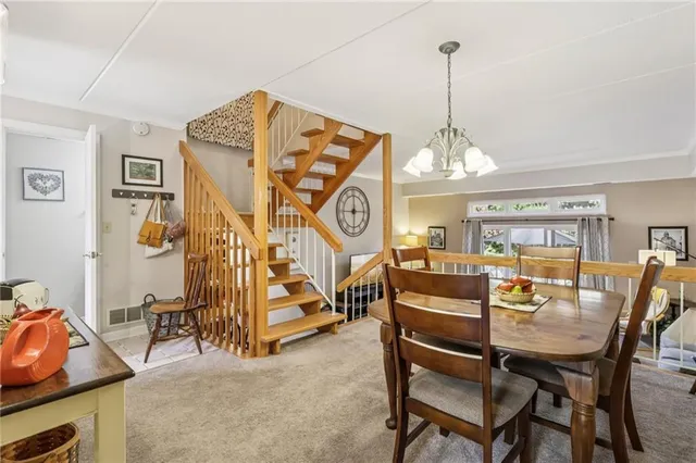 a view of a room with furniture and a chandelier