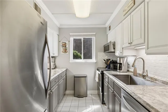 a kitchen with stainless steel appliances granite countertop a sink stove and a refrigerator