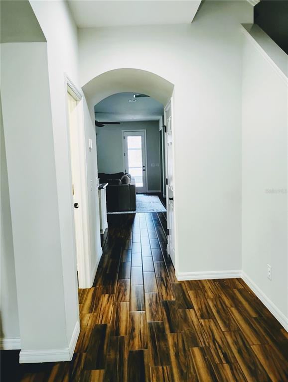 5107 Autumn Ridge Drive Wesley Chapel, FL 33545 - Photo 11 of 35 a view of a hallway with wooden floor and staircase