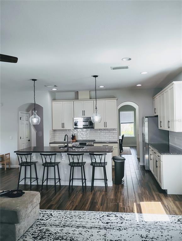 5107 Autumn Ridge Drive Wesley Chapel, FL 33545 - Photo 6 of 35 a large kitchen with a table and chairs