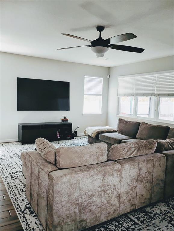 5107 Autumn Ridge Drive Wesley Chapel, FL 33545 - Photo 8 of 35 a living room with a couch and a flat screen tv