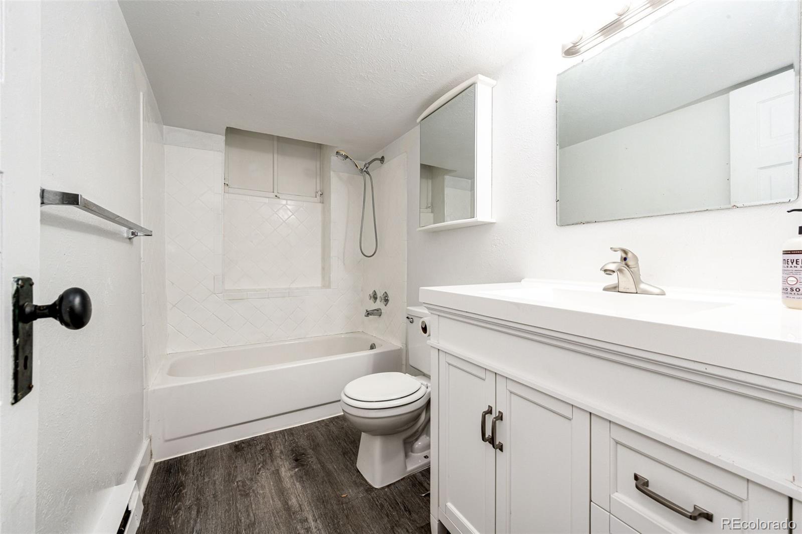 1401 Fillmore Street, Unit 5 Denver, CO 80206 - Photo 13 of 19 a bathroom with a sink a toilet and shower