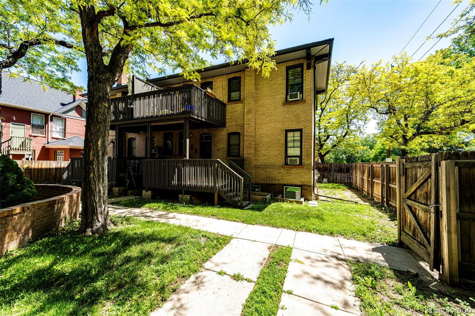 1401 Fillmore Street, Unit 5 Denver, CO 80206 - Photo 16 of 19 a view of a house with a yard