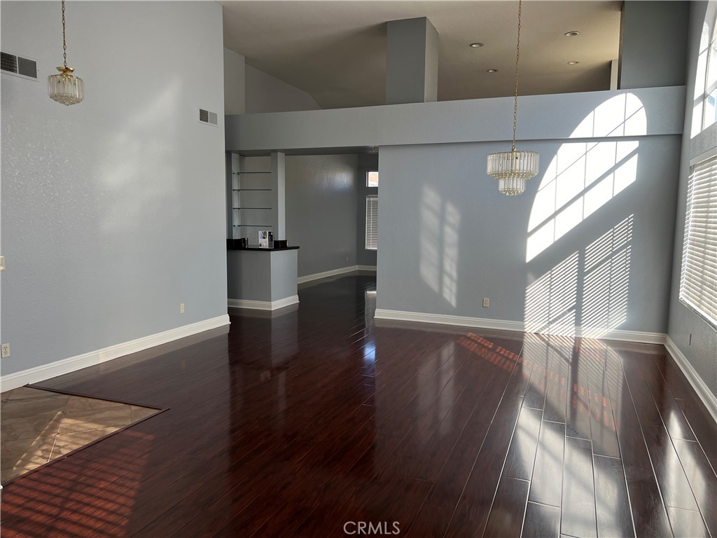 7461 Red Clover Way Highland, CA 92346 - Photo 11 of 35 a view of an empty room with wooden floor and a window