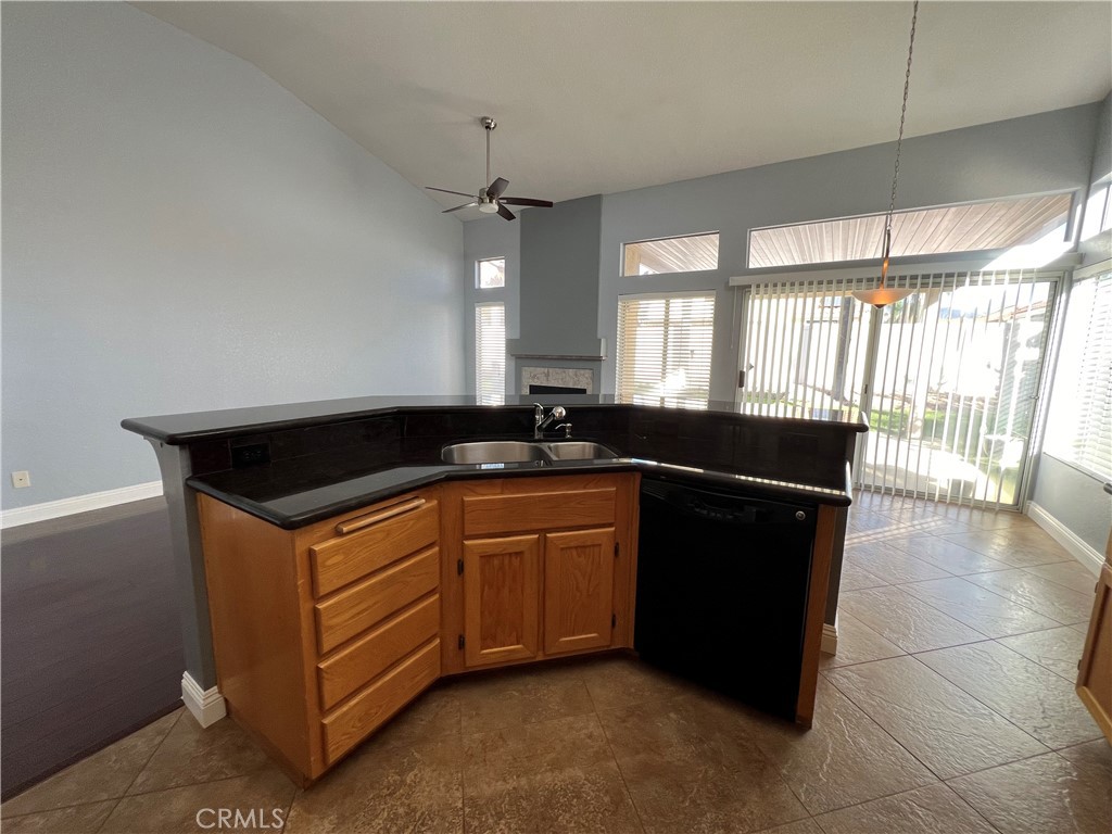 7461 Red Clover Way Highland, CA 92346 - Photo 18 of 35 a kitchen with granite countertop a sink and a counter top space