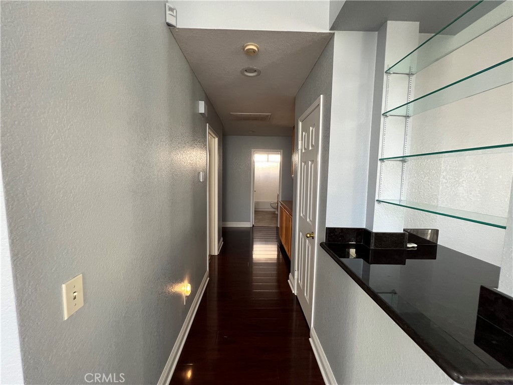 7461 Red Clover Way Highland, CA 92346 - Photo 19 of 35 a view of a hallway with wooden floor and staircase