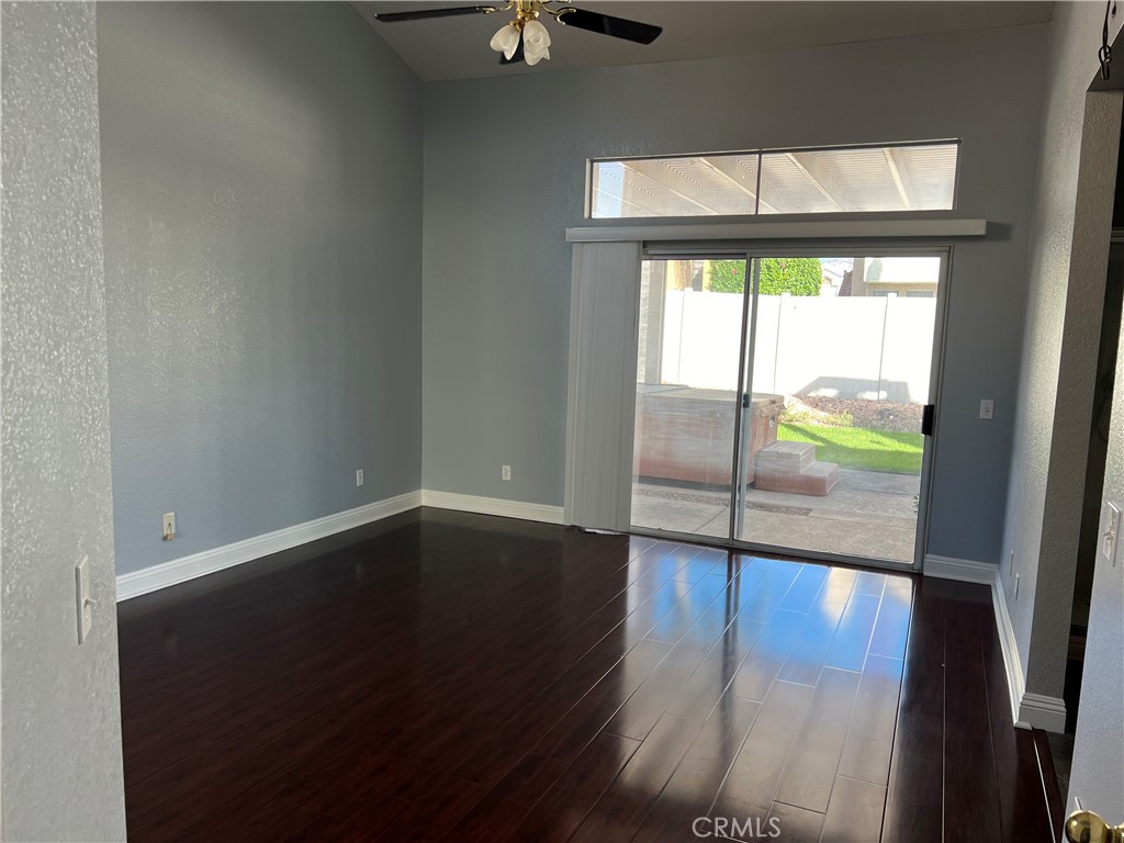 7461 Red Clover Way Highland, CA 92346 - Photo 22 of 35 en empty room with wooden floor and fan