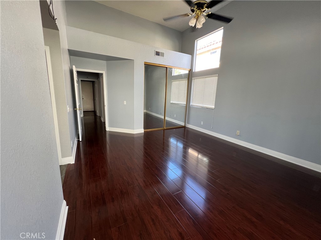 7461 Red Clover Way Highland, CA 92346 - Photo 25 of 35 a view of an empty room with wooden floor and a window