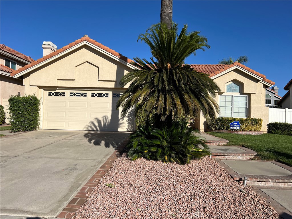 7461 Red Clover Way Highland, CA 92346 - Photo 5 of 35 a front view of a house with a yard and garage