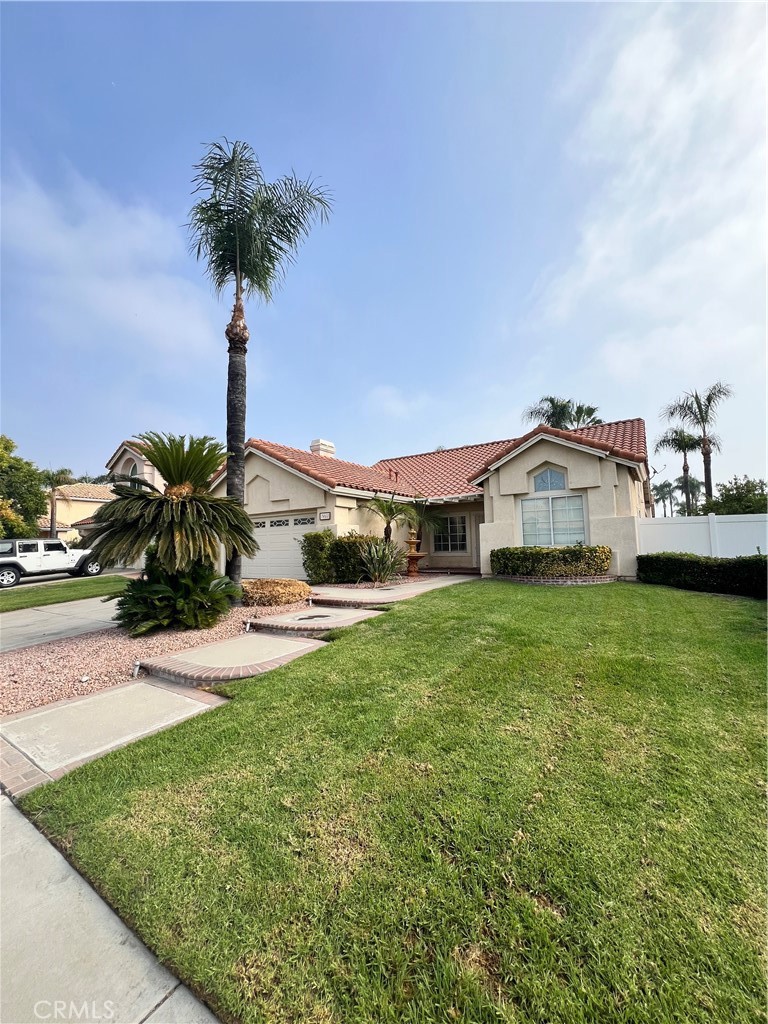 7461 Red Clover Way Highland, CA 92346 - Photo 6 of 35 a front view of a house with garden