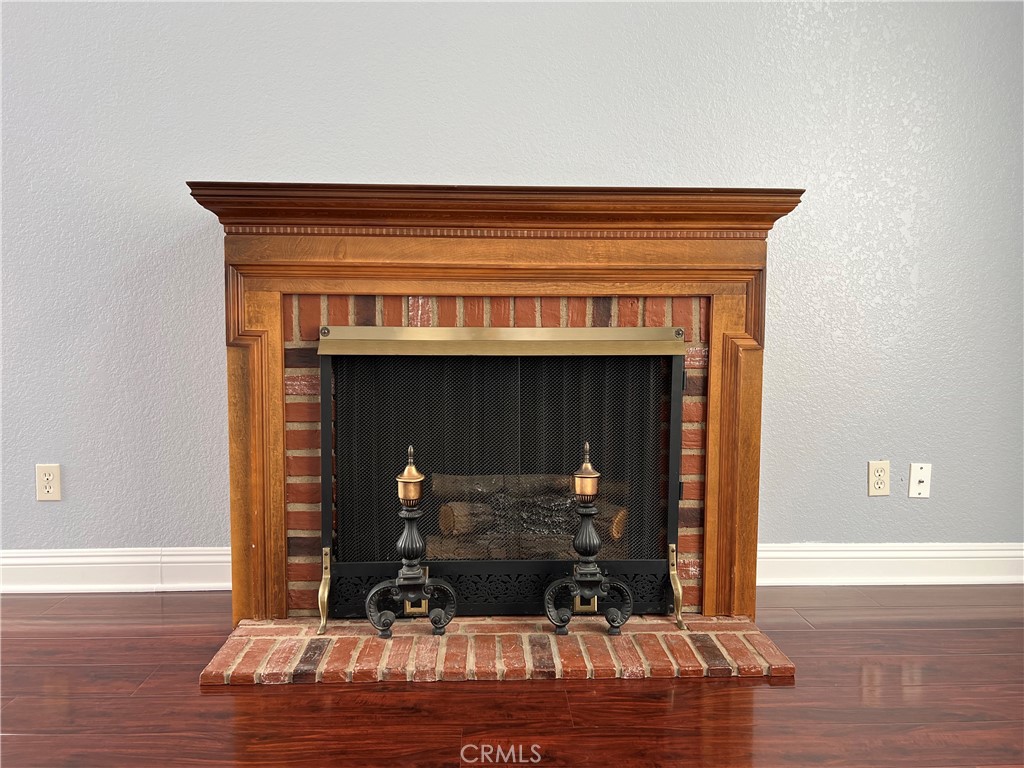 7461 Red Clover Way Highland, CA 92346 - Photo 10 of 35 a room with a fireplace and wooden floor