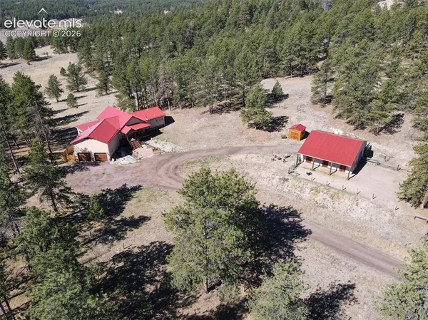 an aerial view of a house with a yard