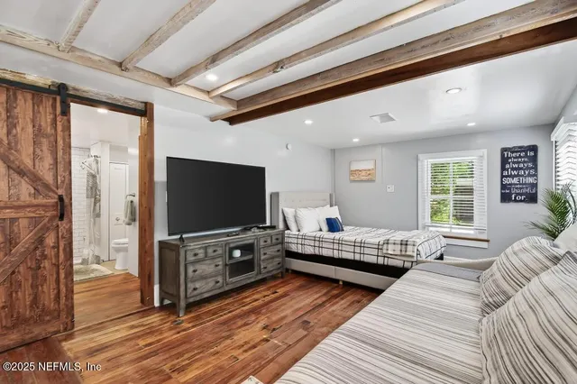 a living room with furniture and wooden floor