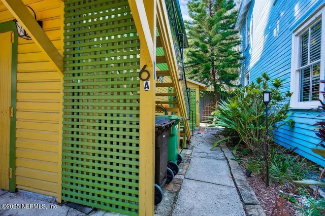 a view of a livingroom with a flat screen tv wooden floor and a ceiling fan