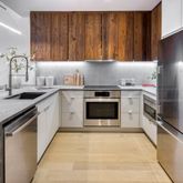a kitchen with a sink stove and refrigerator