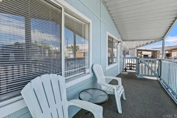a kitchen with stainless steel appliances granite countertop a refrigerator a sink a stove a dining table and chairs