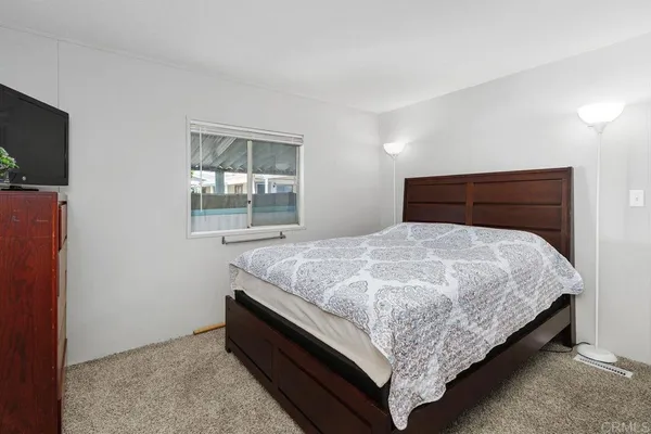 a bedroom with a bed and a couch