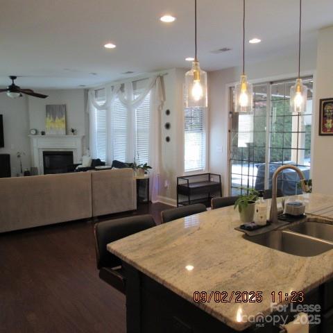 7314 Vesper Drive Huntersville, NC 28078 - Photo 13 of 24 a kitchen with stainless steel appliances granite countertop a sink a stove top oven a counter space and living room view