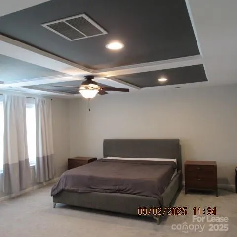 a bedroom with a bed and a ceiling fan